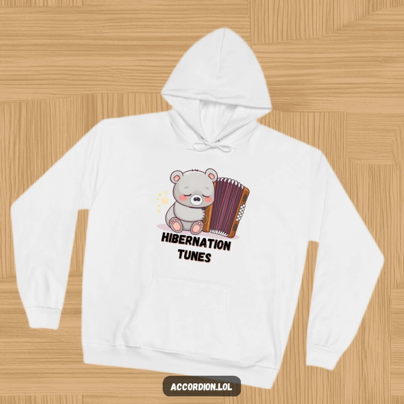 Funny grey bear character wearing a hoodie and sleeping near a closed ornate brown accordion, designed for ultimate coziness.